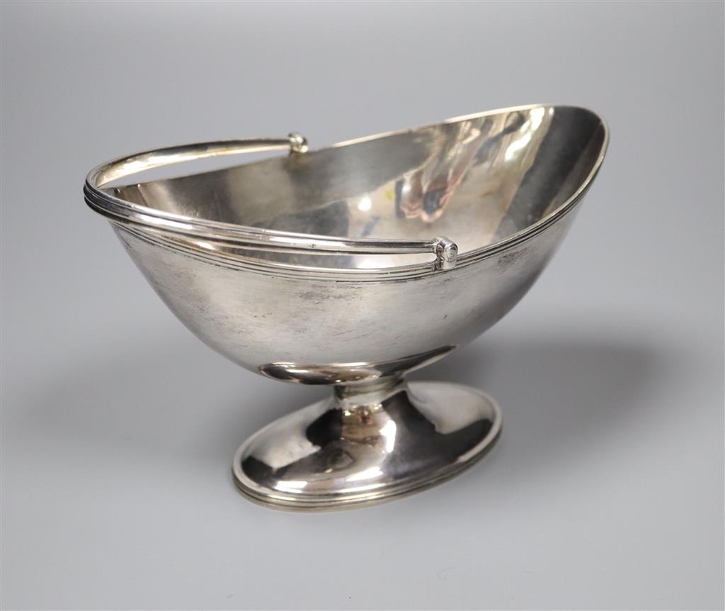 A Victorian oval silver swing-handled sugar basket, having thread edge, Sheffield, 1888, height 10.3cm, 5oz.